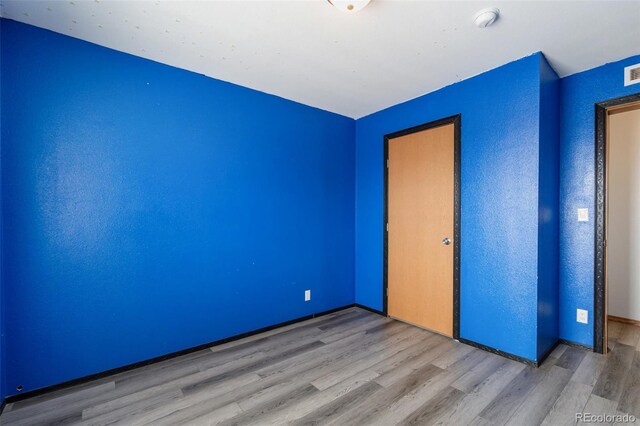 1134 Buffalo Run Rd, Calhan, CO 80808 - unfurnished bedroom with wood finished floors and baseboards