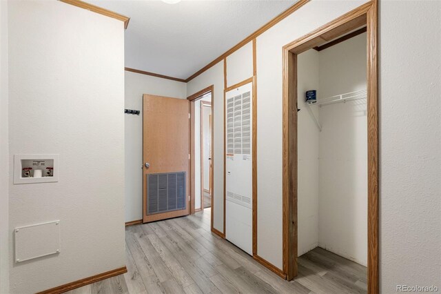 1134 Buffalo Run Rd, Calhan, CO 80808 - hallway with a heating unit, light wood-style floors, crown molding, and baseboards