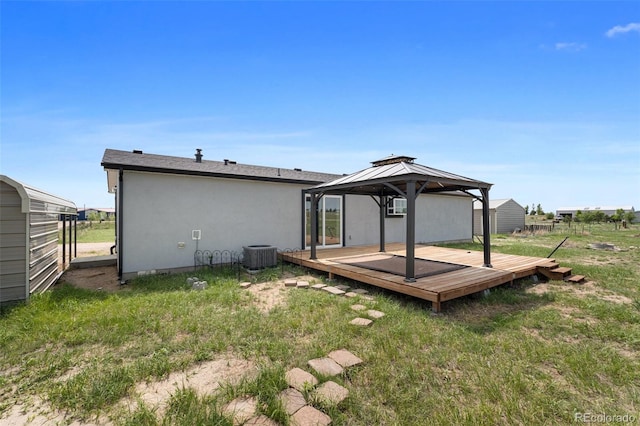 1134 Buffalo Run Rd, Calhan, CO 80808 - rear view of property featuring a gazebo, a deck, central air condition unit, stucco siding, and a yard