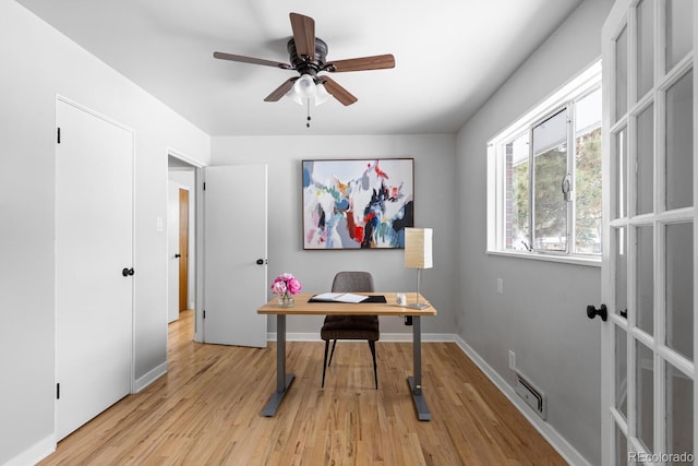 home office featuring light hardwood / wood-style floors and ceiling fan