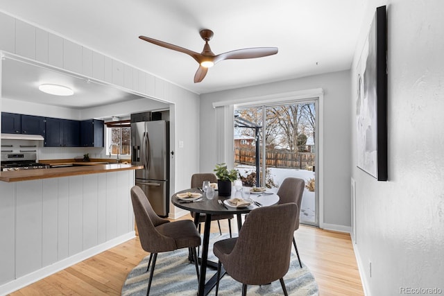 dining space featuring sink, light hardwood / wood-style floors, and ceiling fan