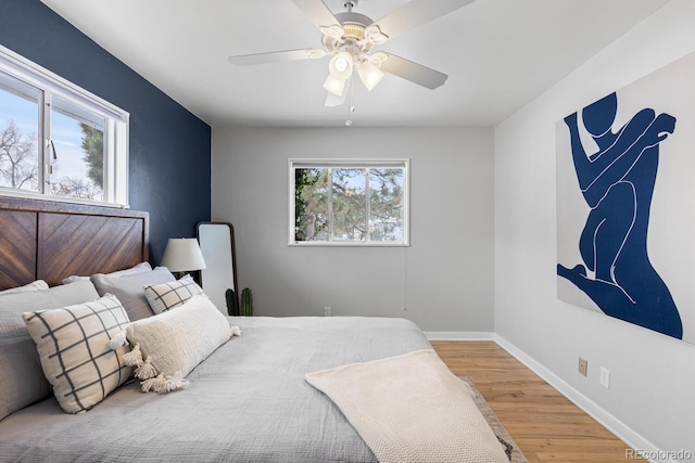 bedroom with ceiling fan and hardwood / wood-style flooring