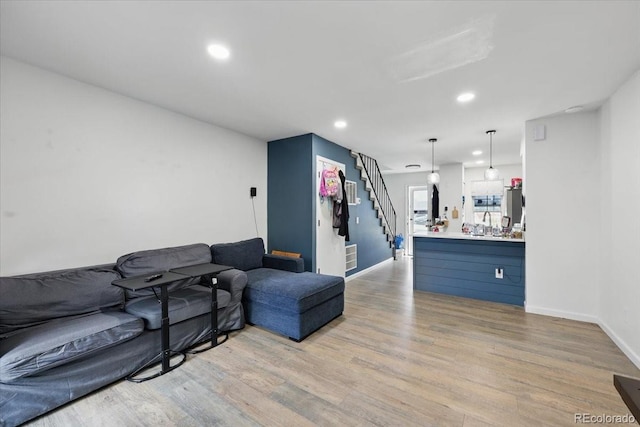 4058 Baytown Dr, Colorado Springs, CO 80916 - living area featuring baseboards, stairs, and light wood-style flooring