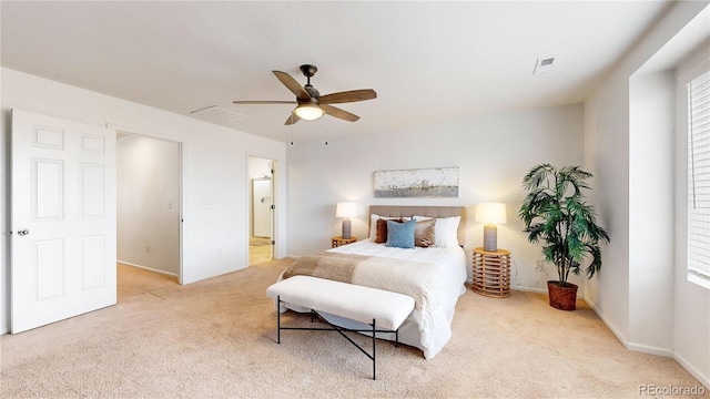 bedroom featuring connected bathroom, ceiling fan, and light colored carpet