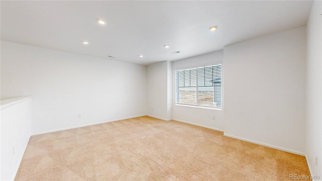 spare room with light colored carpet