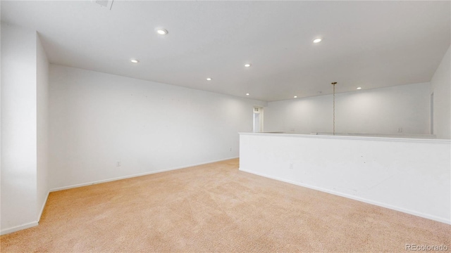 spare room featuring light colored carpet