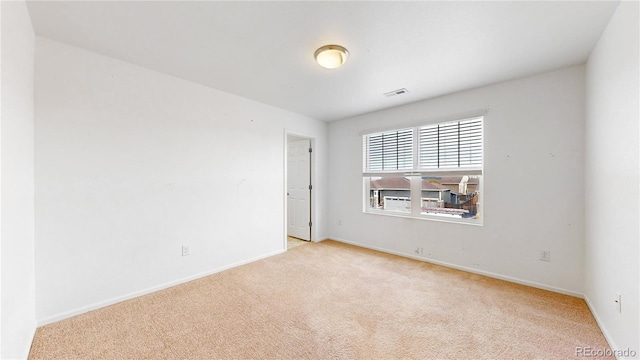 empty room with light colored carpet