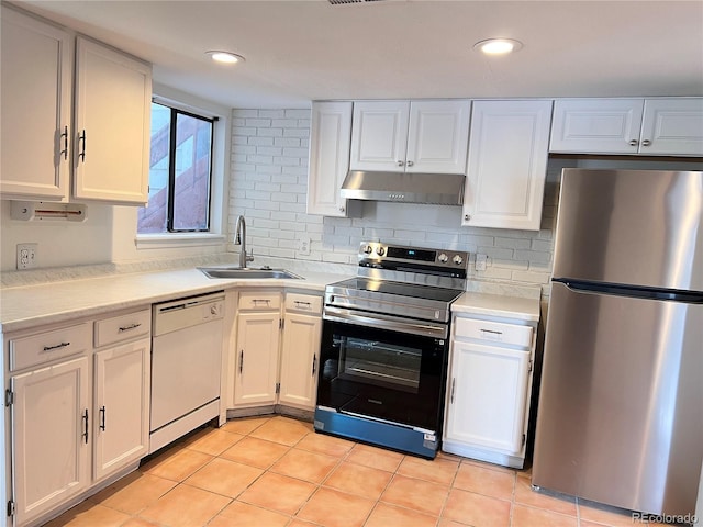 kitchen featuring under cabinet range hood, white cabinetry, appliances with stainless steel finishes, and light countertops