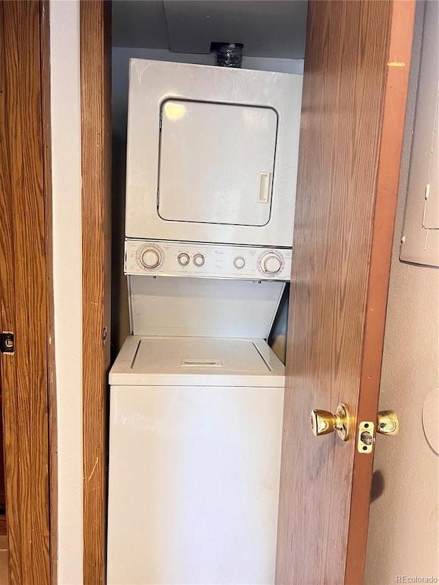 laundry room with stacked washer and dryer and laundry area