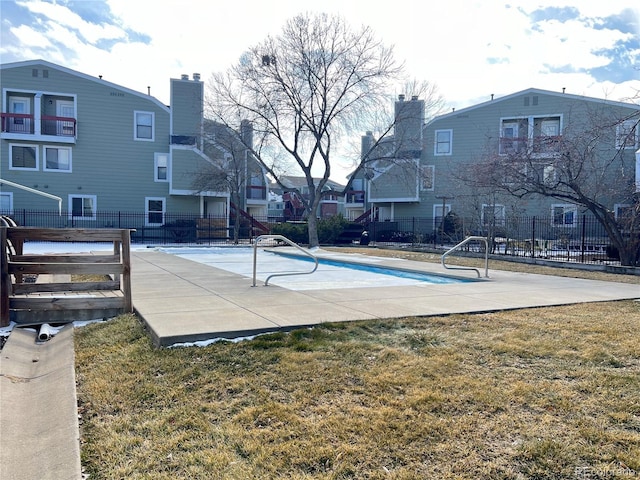 exterior space featuring a patio area, fence, and a lawn