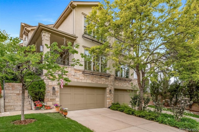 581 Garfield St, Denver, CO 80206 - view of front of home with stucco siding, stone siding, an attached garage, driveway, and stairway