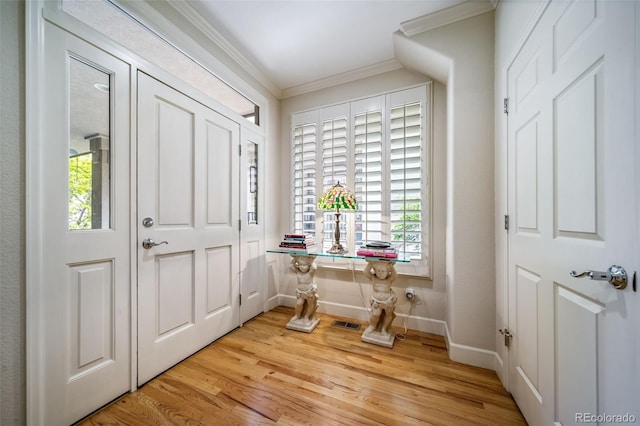 581 Garfield St, Denver, CO 80206 - entrance foyer with crown molding and light wood-style floors