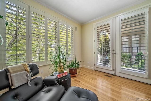 581 Garfield St, Denver, CO 80206 - living area with crown molding, wood finished floors, and plenty of natural light