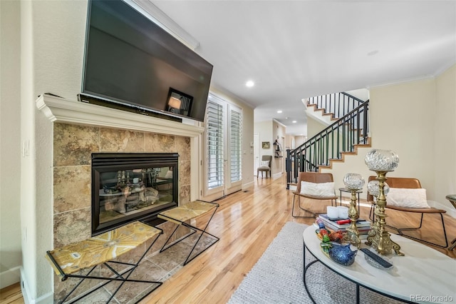 581 Garfield St, Denver, CO 80206 - living area with wood finished floors, stairway, a tile fireplace, ornamental molding, and recessed lighting