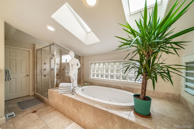 581 Garfield St, Denver, CO 80206 - bathroom with a skylight, a whirlpool tub, a stall shower, vaulted ceiling, and tile patterned flooring