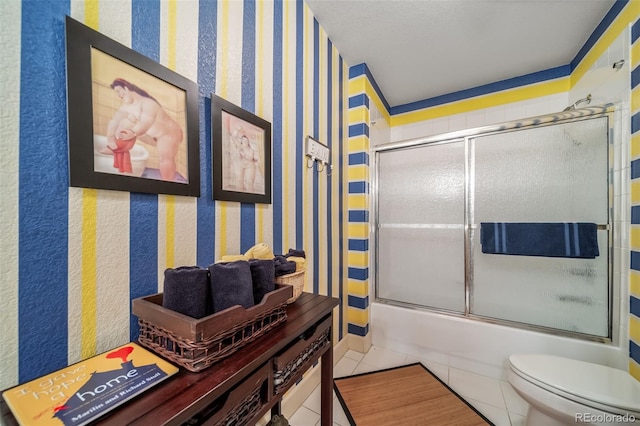 581 Garfield St, Denver, CO 80206 - bathroom with tile patterned floors, combined bath / shower with glass door, and wallpapered walls