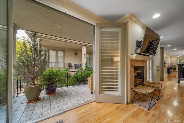 581 Garfield St, Denver, CO 80206 - doorway to outside with wood finished floors, a tiled fireplace, and recessed lighting