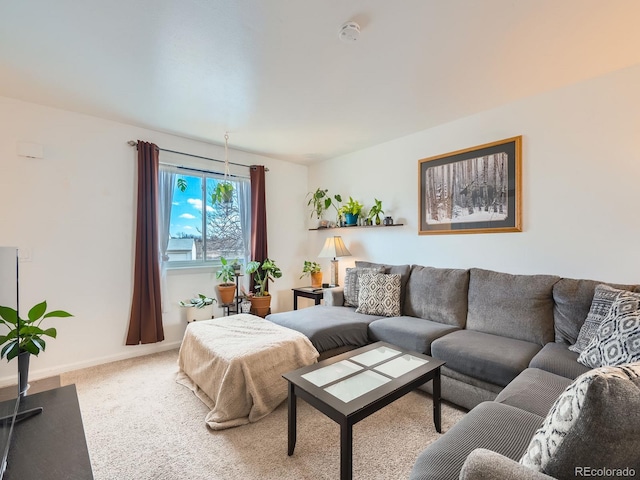 living room featuring carpet and baseboards