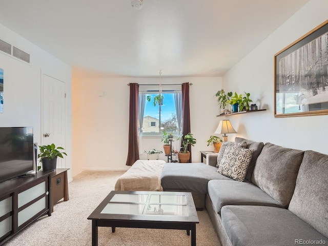 living area with light colored carpet and visible vents