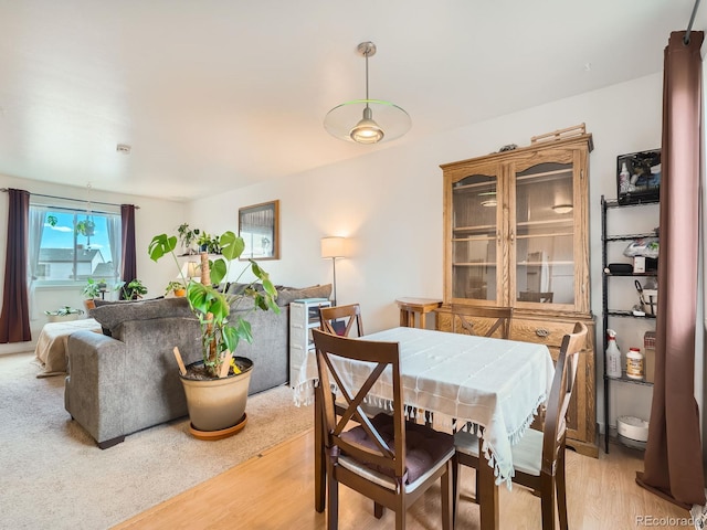 dining area with light wood-style flooring