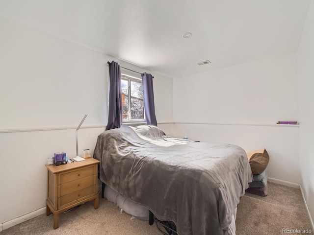 bedroom featuring light carpet, visible vents, and baseboards