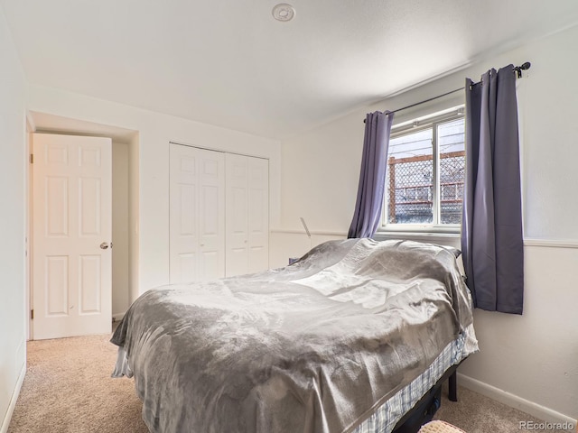 bedroom with carpet, a closet, and baseboards