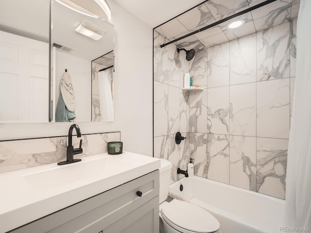 bathroom featuring shower / bath combo, visible vents, vanity, and toilet