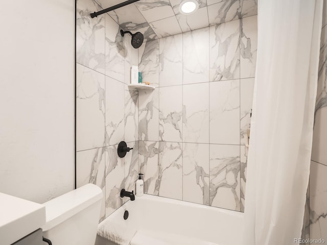 bathroom featuring shower / tub combo and toilet