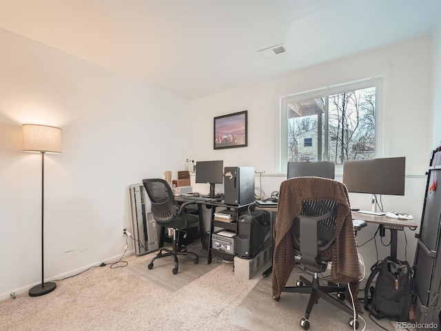 carpeted office space featuring visible vents and baseboards