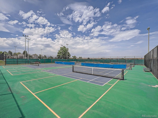 view of tennis court featuring fence