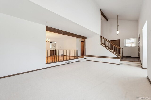 4855 S Joplin St, Aurora, CO 80015 - unfurnished living room featuring high vaulted ceiling, carpet, stairway, a chandelier, and baseboards