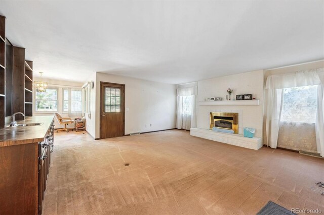 4855 S Joplin St, Aurora, CO 80015 - unfurnished living room with a sink, light carpet, and plenty of natural light