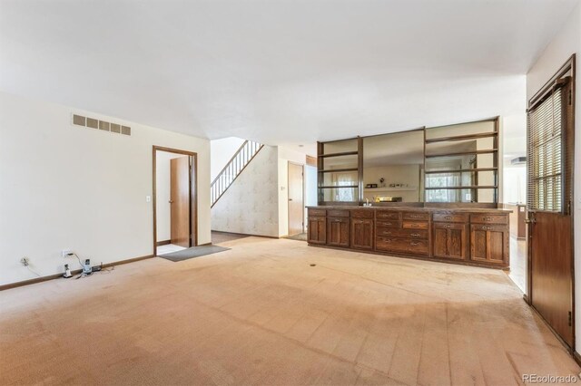 4855 S Joplin St, Aurora, CO 80015 - unfurnished living room featuring light carpet, stairway, and baseboards