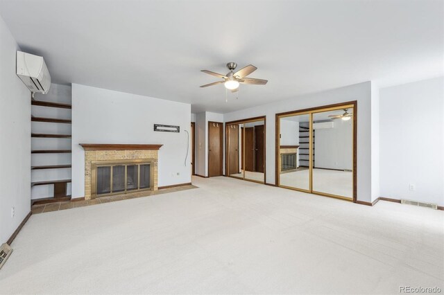 4855 S Joplin St, Aurora, CO 80015 - unfurnished living room with an AC wall unit, a ceiling fan, a fireplace with flush hearth, stairs, and carpet flooring