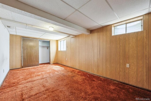 4855 S Joplin St, Aurora, CO 80015 - basement featuring wooden walls, carpet, and a paneled ceiling