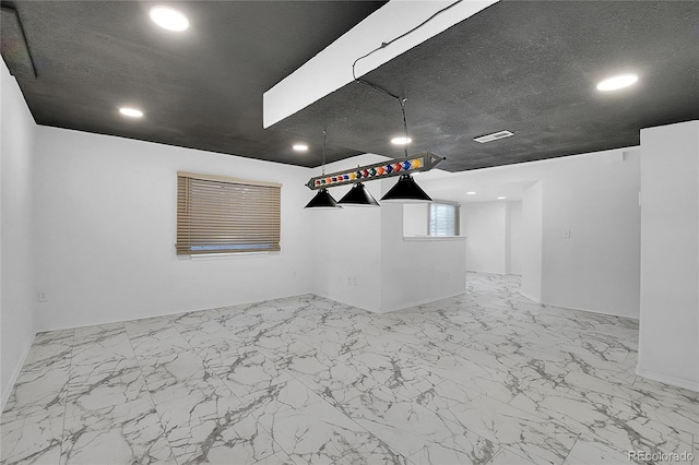 spare room with baseboards, visible vents, marble finish floor, a textured ceiling, and recessed lighting