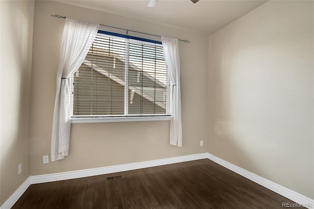 spare room featuring wood-type flooring and ceiling fan