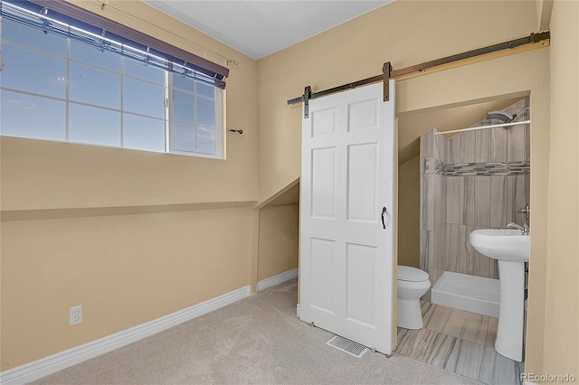 full bathroom featuring toilet, a stall shower, visible vents, and baseboards