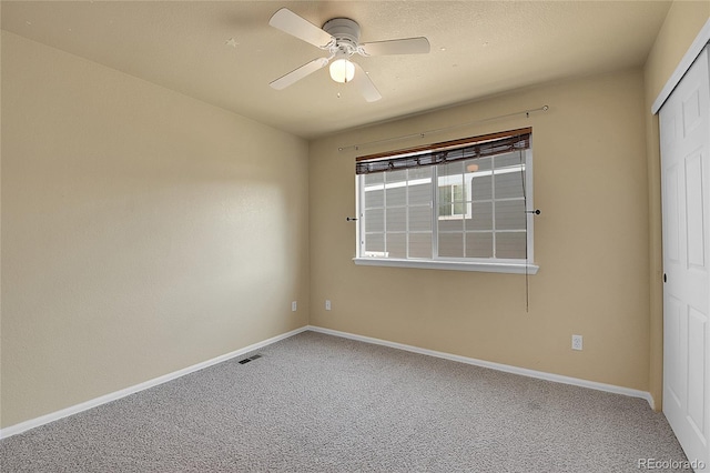 unfurnished bedroom featuring carpet flooring, ceiling fan, and a closet