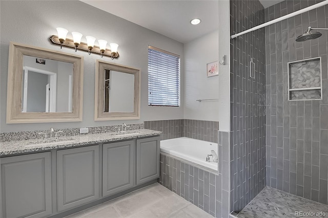 bathroom with tile patterned flooring, shower with separate bathtub, and vanity