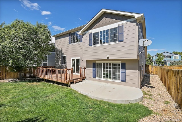 rear view of property featuring a yard and a wooden deck