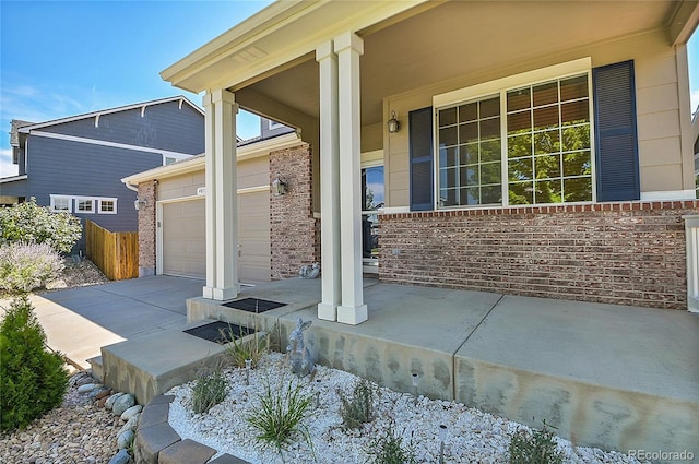 view of patio / terrace with a porch and a garage