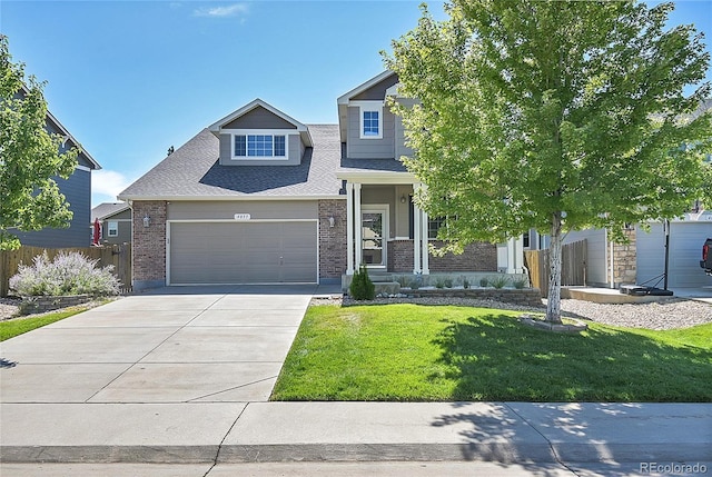 view of front of home featuring a front yard, a garage, and covered porch