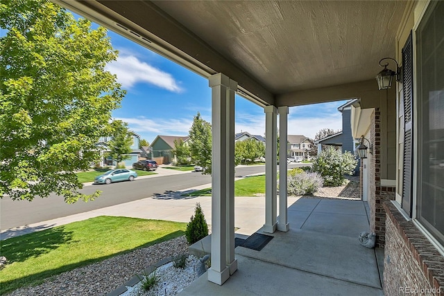 view of patio featuring covered porch and a residential view