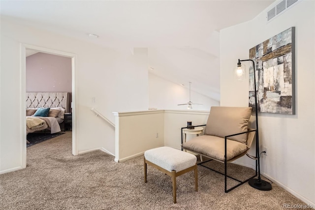 living area with lofted ceiling and carpet flooring