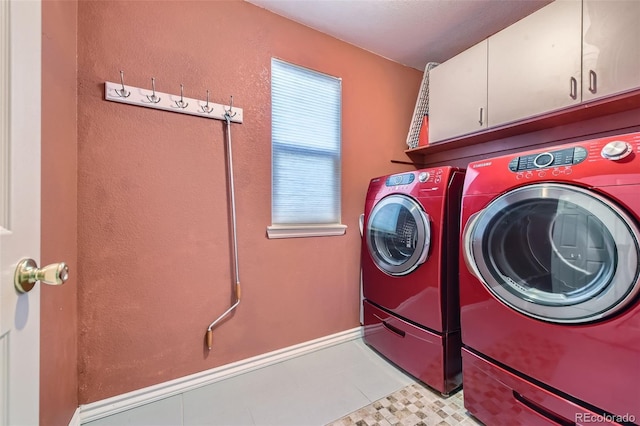 laundry room featuring cabinets and washing machine and dryer