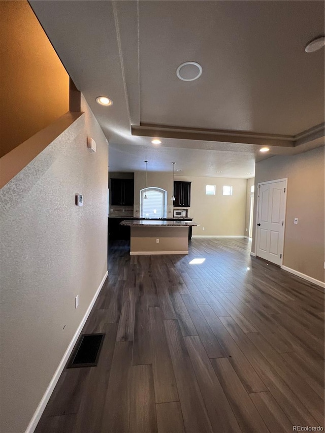 unfurnished living room with dark hardwood / wood-style flooring