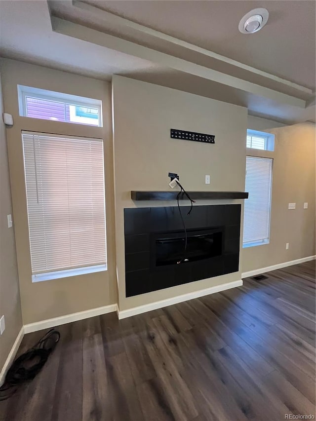 unfurnished living room with dark wood-type flooring