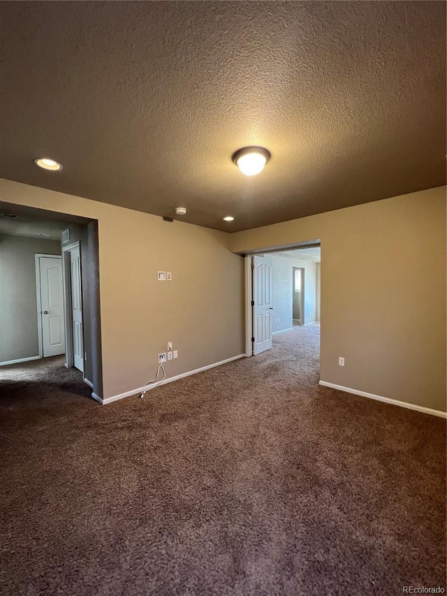 carpeted spare room featuring a textured ceiling