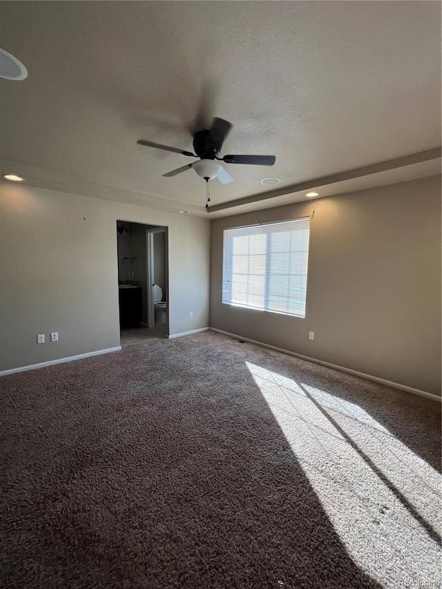 carpeted spare room with ceiling fan